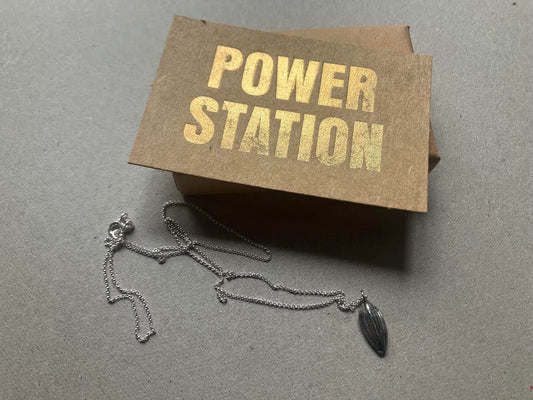 Cast sunflower seed pendant