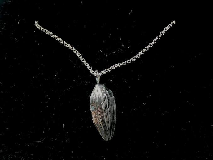 Cast sunflower seed pendant
