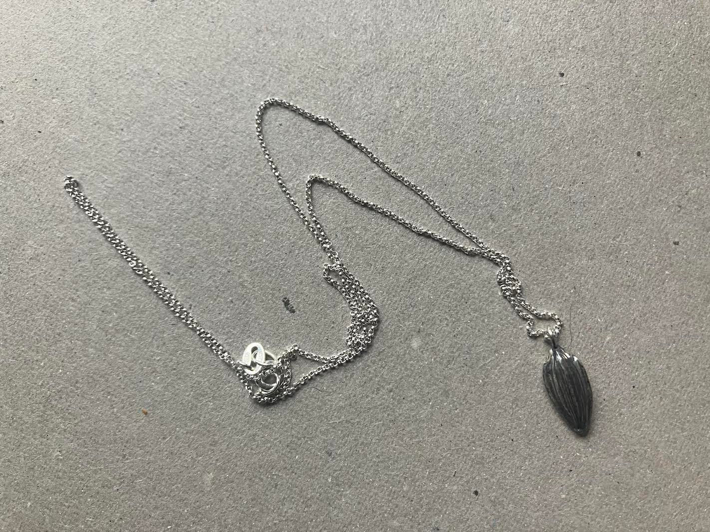 Cast sunflower seed pendant