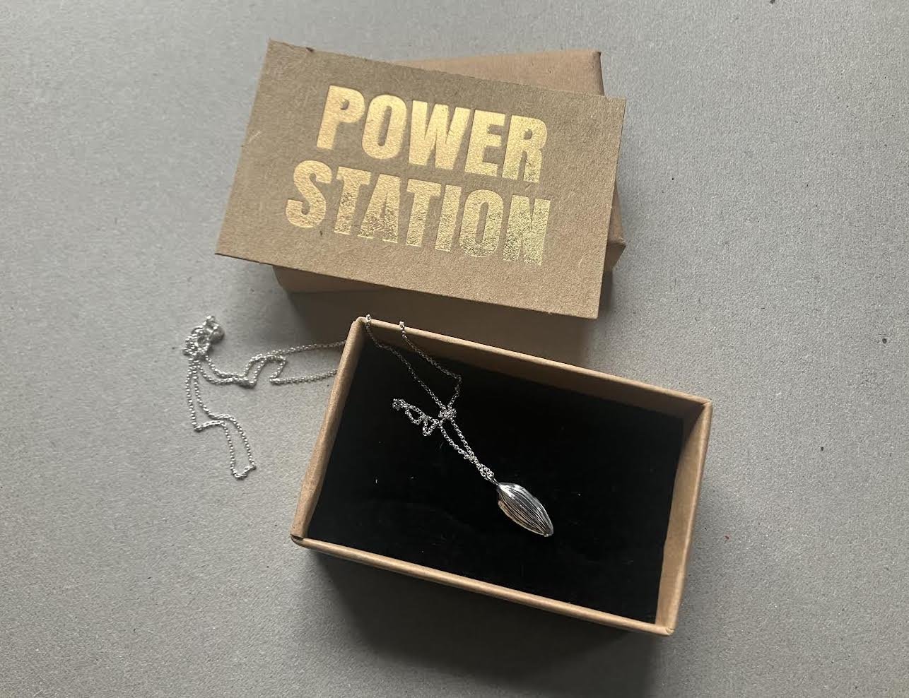 Cast sunflower seed pendant